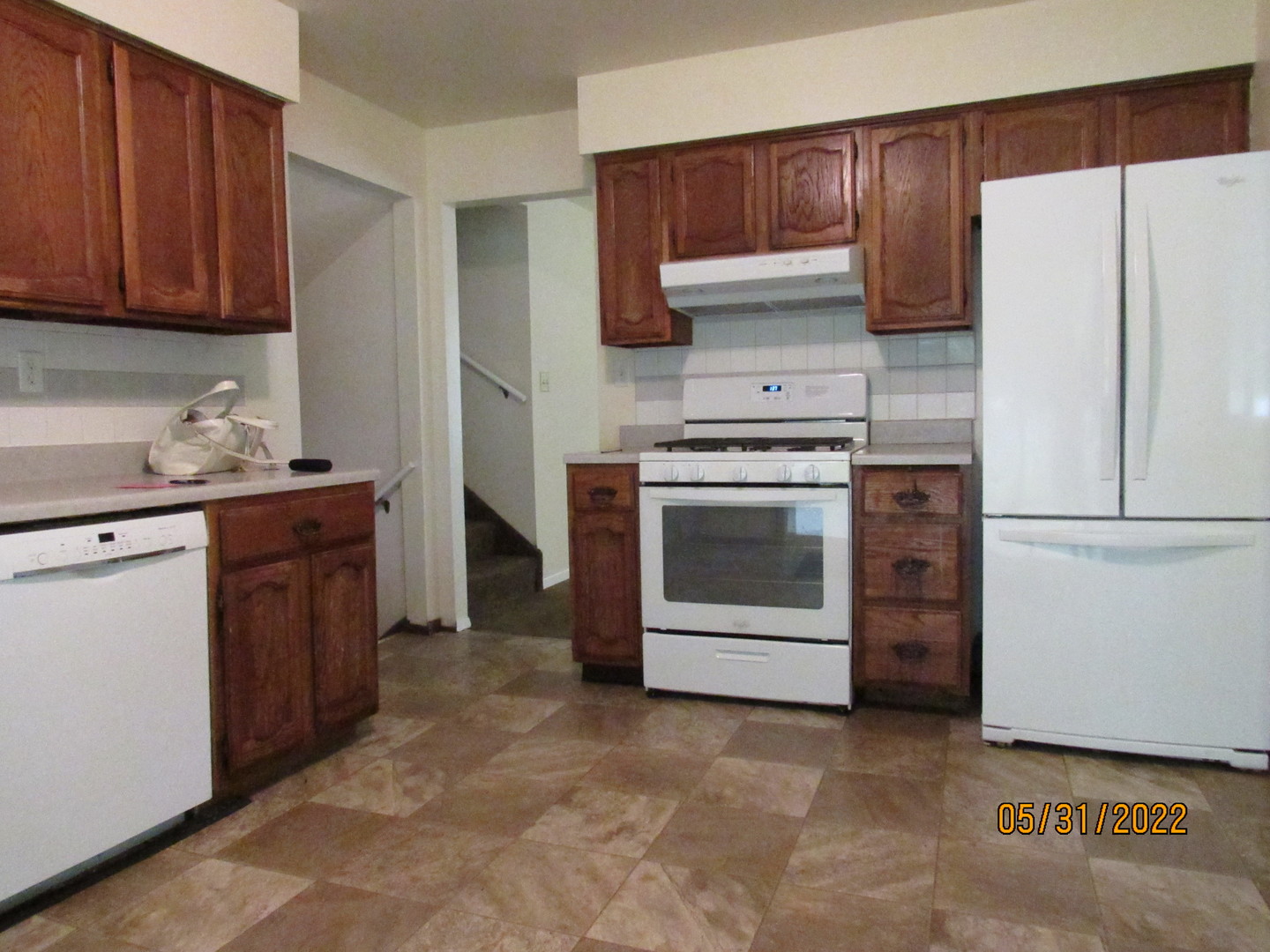 817 Normal Road DeKalb, IL 60115 - Photo 8 of 24 a kitchen with a stove top oven and refrigerator
