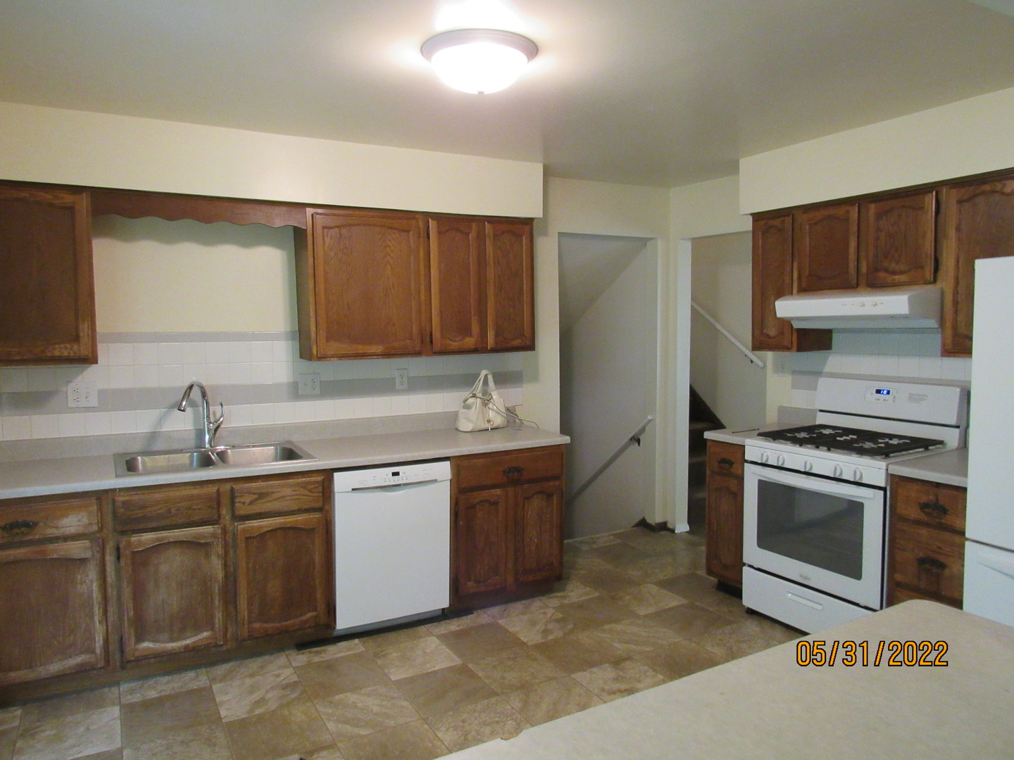 817 Normal Road DeKalb, IL 60115 - Photo 9 of 24 a kitchen with stainless steel appliances granite countertop a sink and a stove top oven
