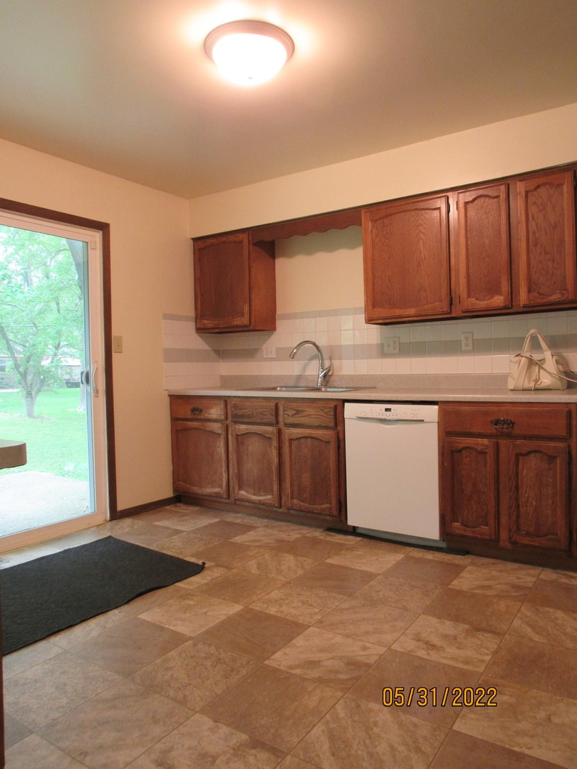 817 Normal Road DeKalb, IL 60115 - Photo 10 of 24 a kitchen with a sink and cabinets