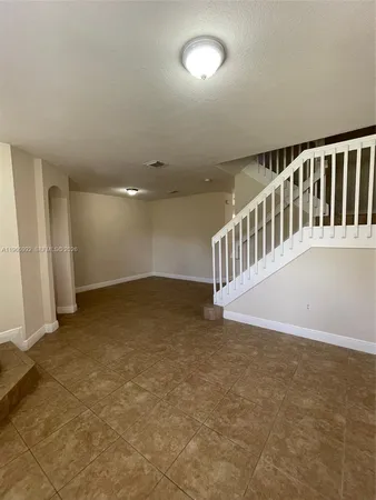 a view of an empty room with stairs