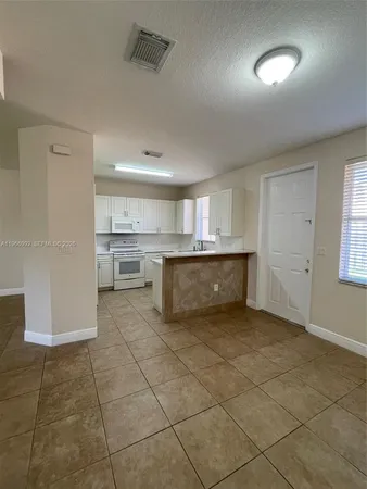 a view of a kitchen with a sink and a stove top oven