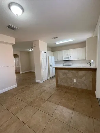 a view of a kitchen with a sink and cabinets