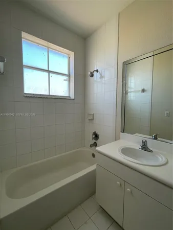 a bathroom with a bathtub and a sink