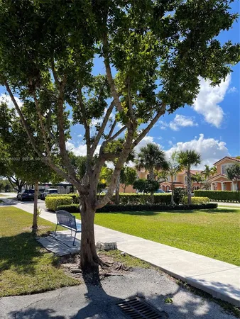 a view of yard with swimming pool and green space