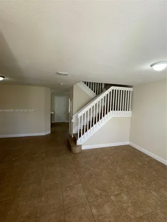 a view of an entryway with a white fence