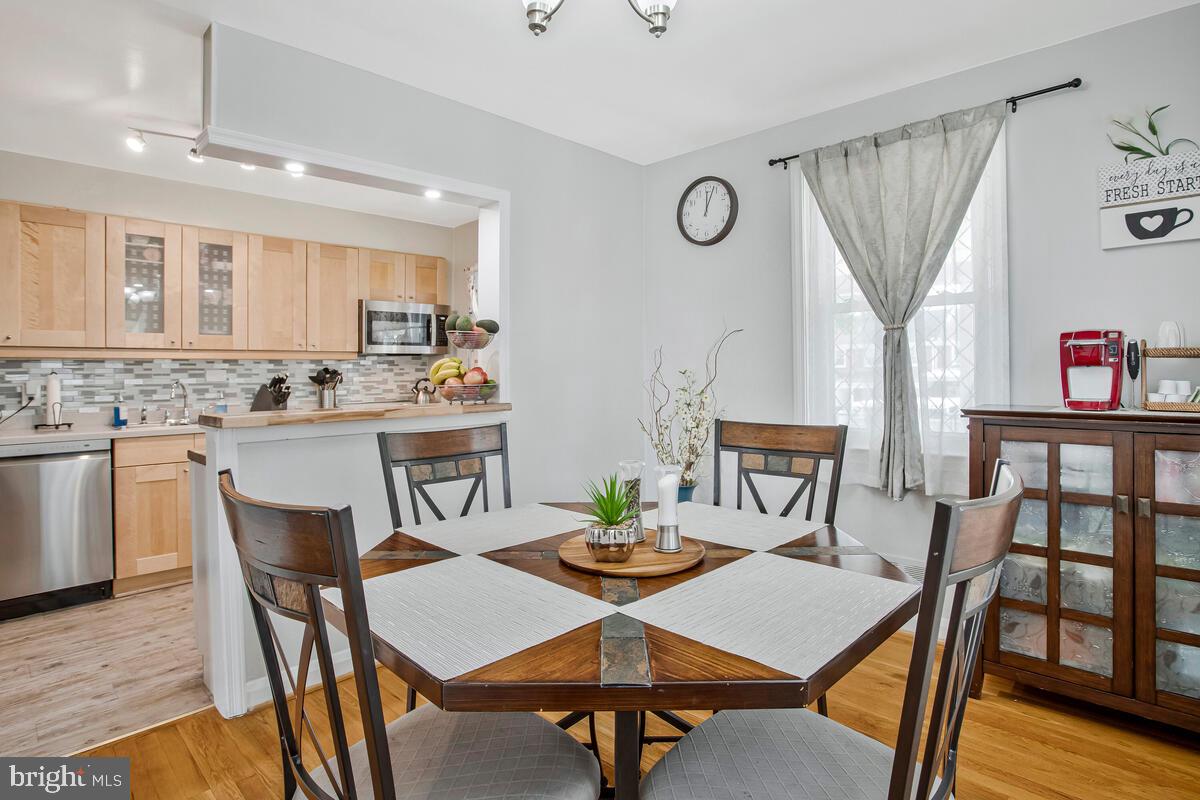7215 Conley Street Baltimore, MD 21224 - Photo 12 of 38 a view of a dining room with furniture and wooden floor