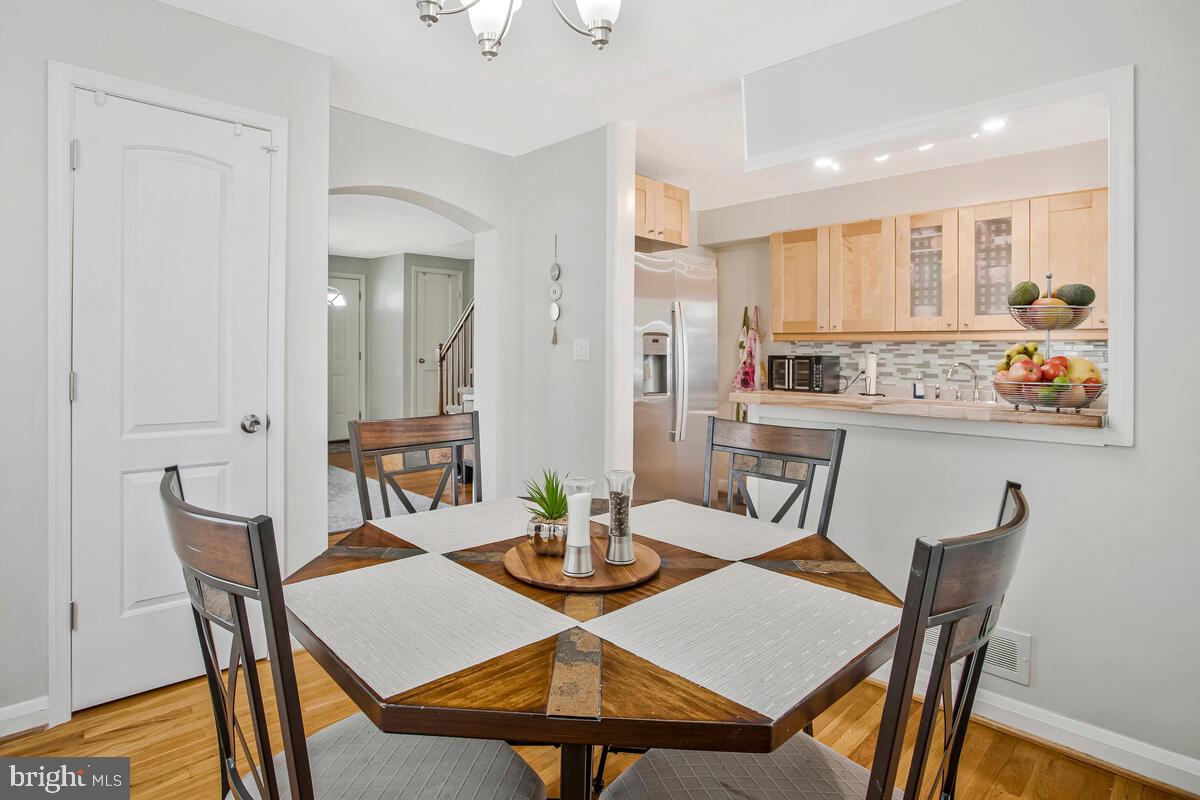 7215 Conley Street Baltimore, MD 21224 - Photo 13 of 38 a view of a dining room with furniture and wooden floor