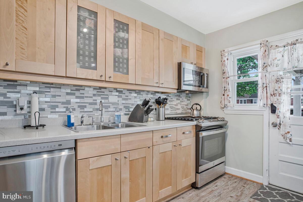 7215 Conley Street Baltimore, MD 21224 - Photo 14 of 38 a kitchen with stainless steel appliances granite countertop a sink stove and cabinets