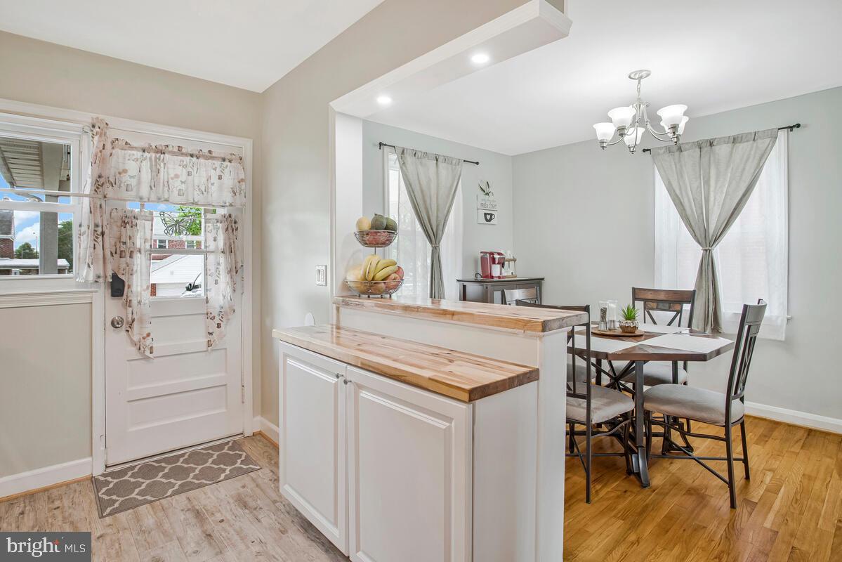 7215 Conley Street Baltimore, MD 21224 - Photo 15 of 38 a view of a dining room with furniture and chandelier