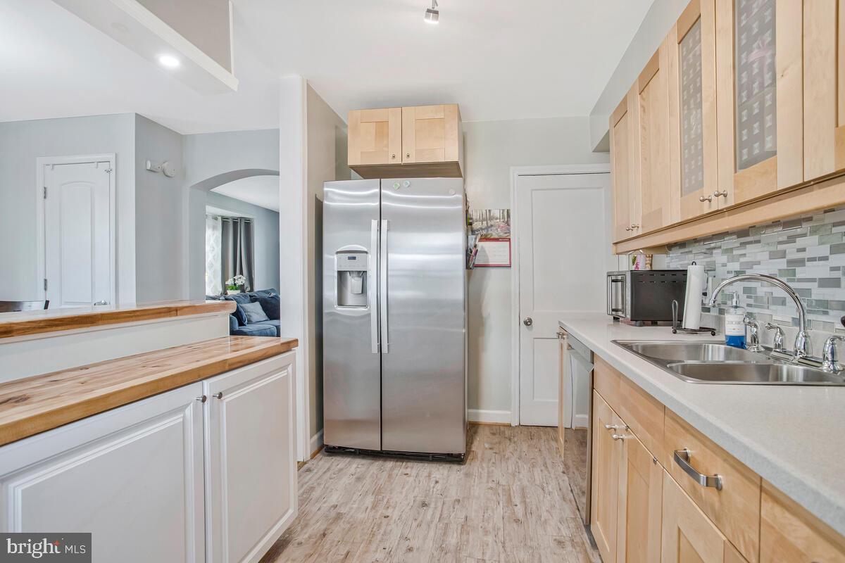 7215 Conley Street Baltimore, MD 21224 - Photo 16 of 38 a kitchen with stainless steel appliances granite countertop a refrigerator and a sink