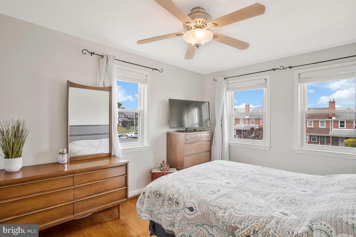 7215 Conley Street Baltimore, MD 21224 - Photo 18 of 38 a bedroom with a bed dresser and a window