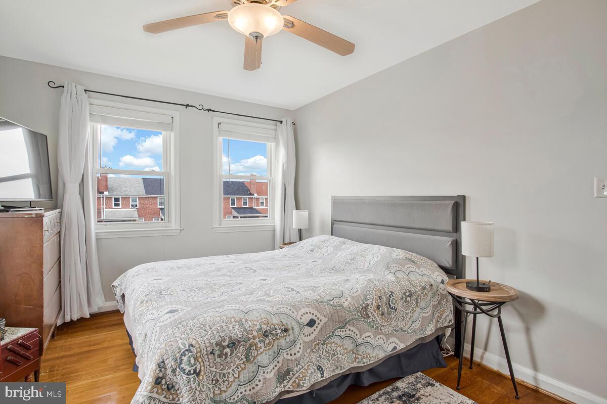 7215 Conley Street Baltimore, MD 21224 - Photo 19 of 38 a bedroom with a bed and a chandelier