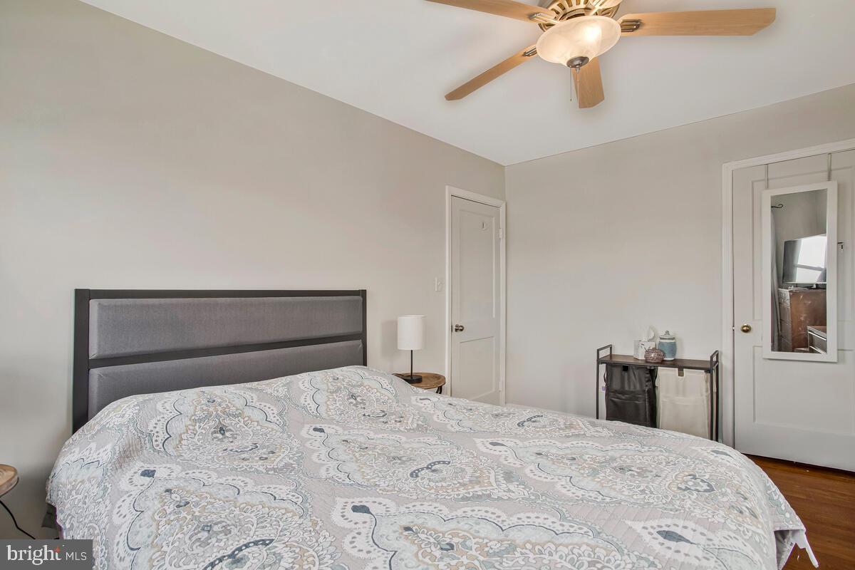 7215 Conley Street Baltimore, MD 21224 - Photo 20 of 38 a bedroom with a bed and a chandelier