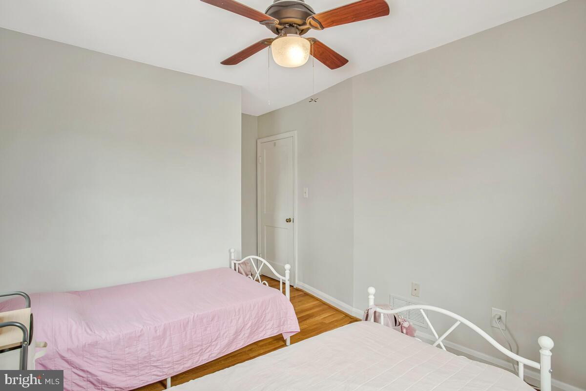 7215 Conley Street Baltimore, MD 21224 - Photo 24 of 38 a bedroom with a bed and a chandelier fan