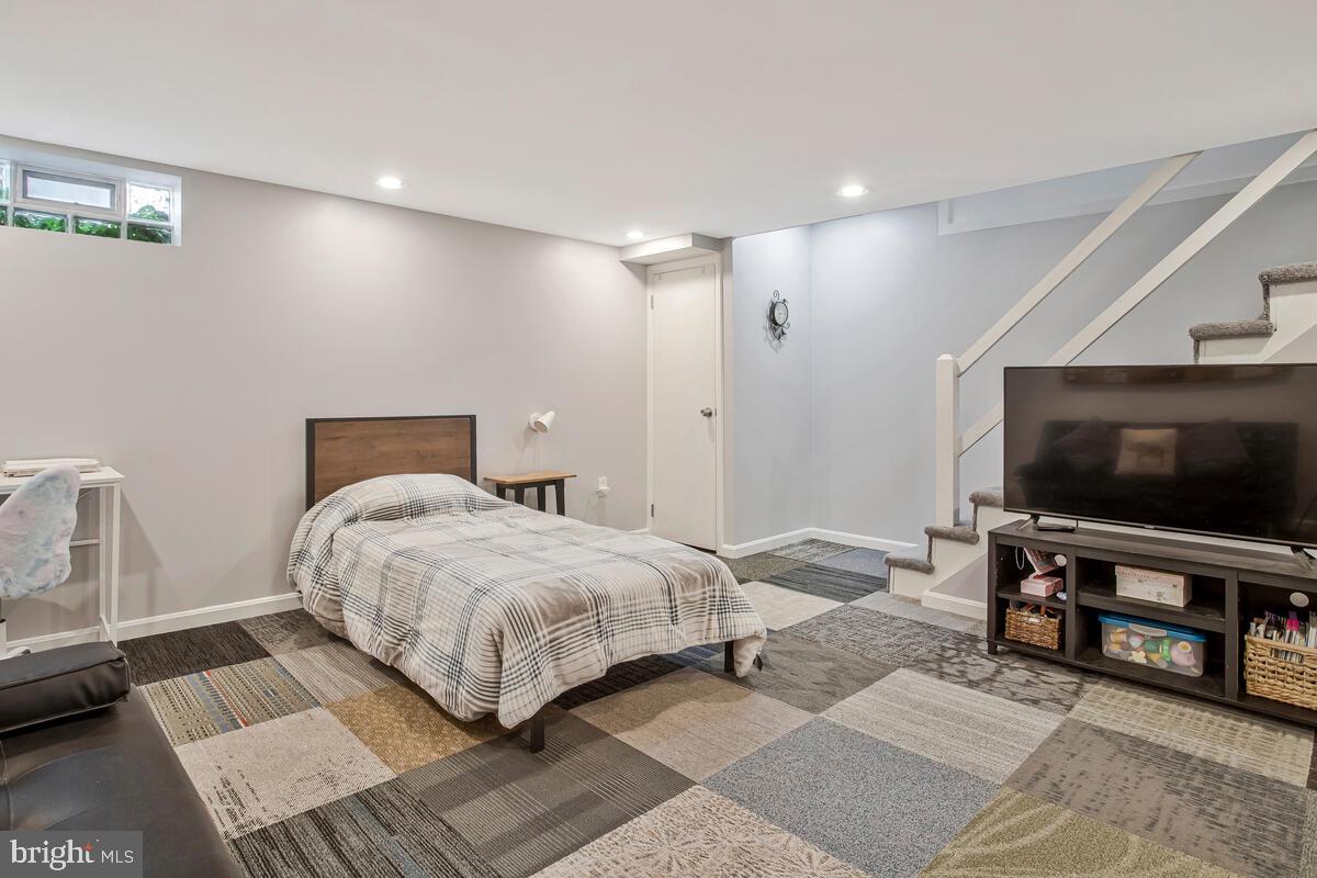 7215 Conley Street Baltimore, MD 21224 - Photo 28 of 38 a bedroom with a bed and a flat screen tv