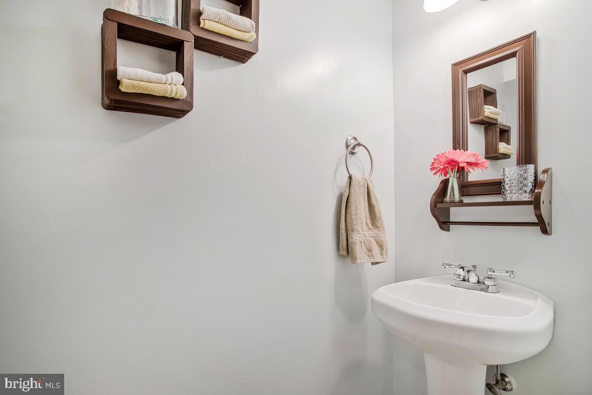7215 Conley Street Baltimore, MD 21224 - Photo 30 of 38 a bathroom with a sink and a mirror