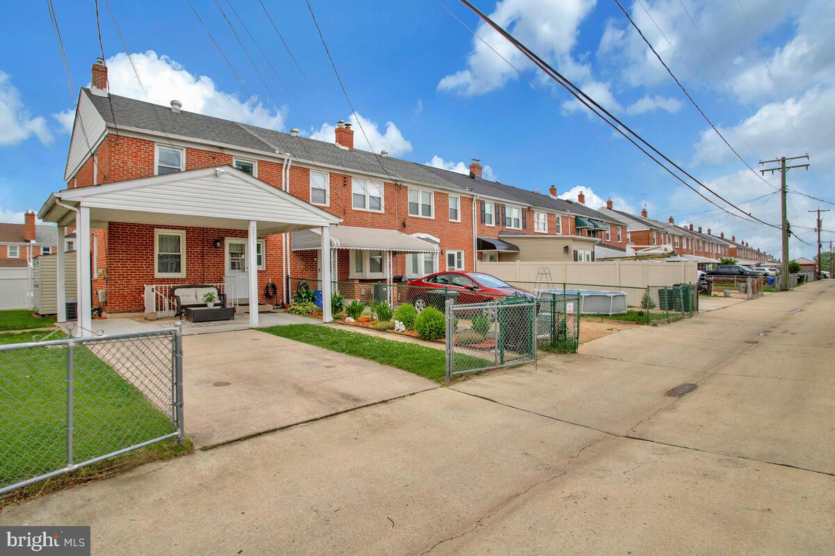 7215 Conley Street Baltimore, MD 21224 - Photo 38 of 38 a front view of a house with a garden and plants