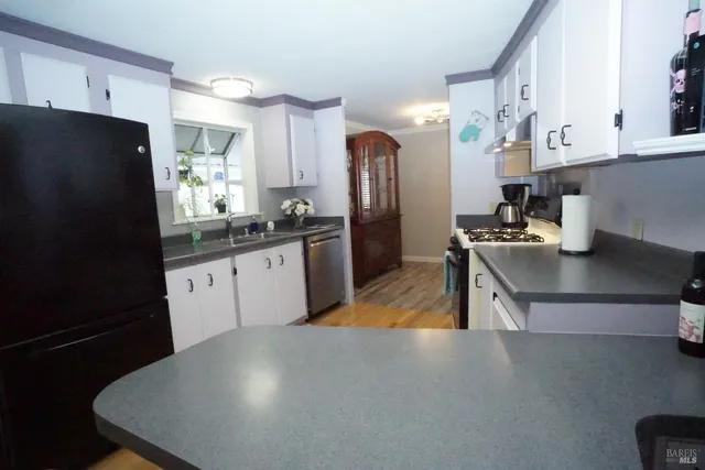 a kitchen with a sink cabinets and a window