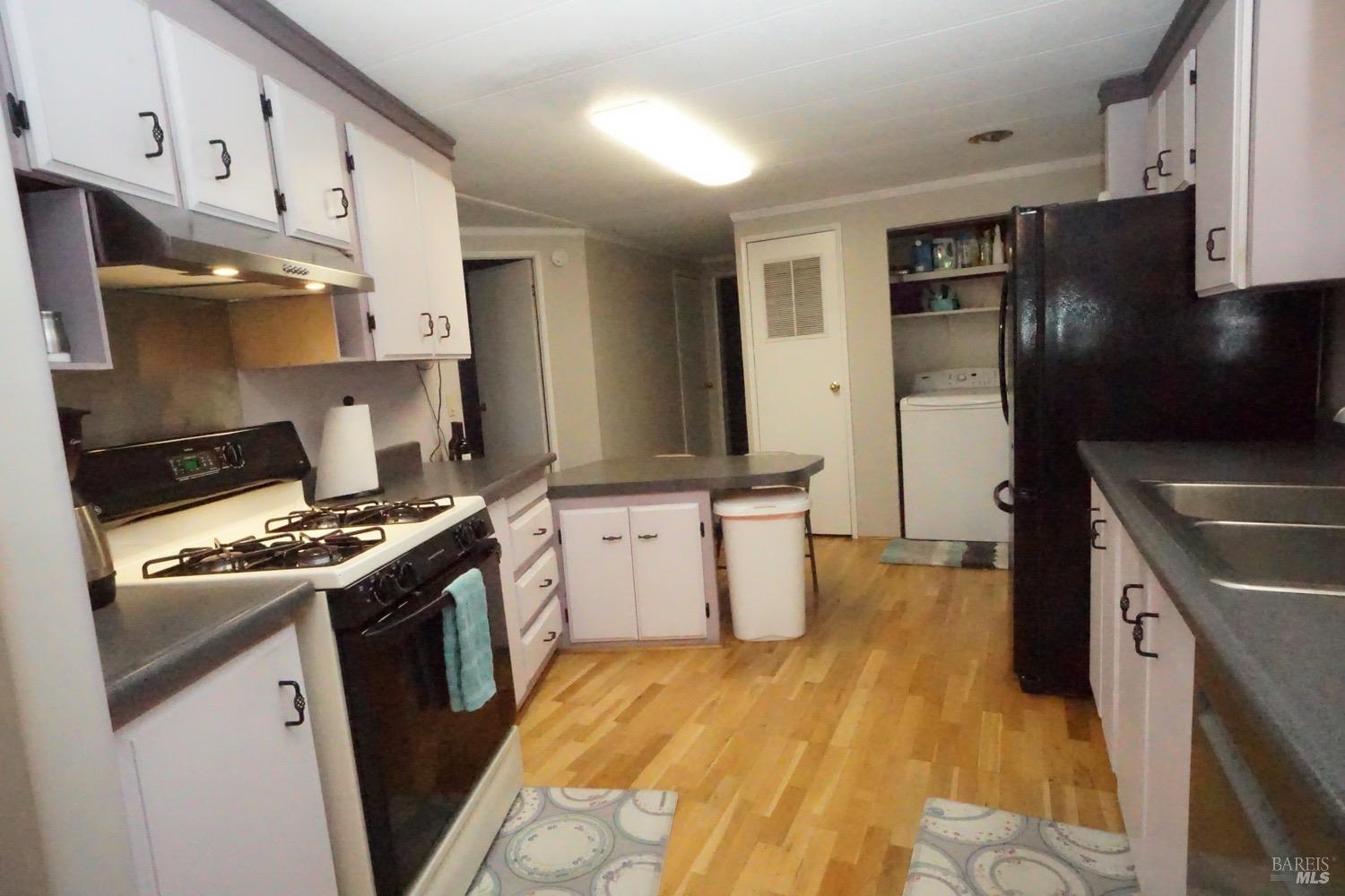 1036 Maple Drive Windsor, CA 95492 - Photo 16 of 28 This view is of the full gas range, refrigerator, looking toward the washer/dryer.