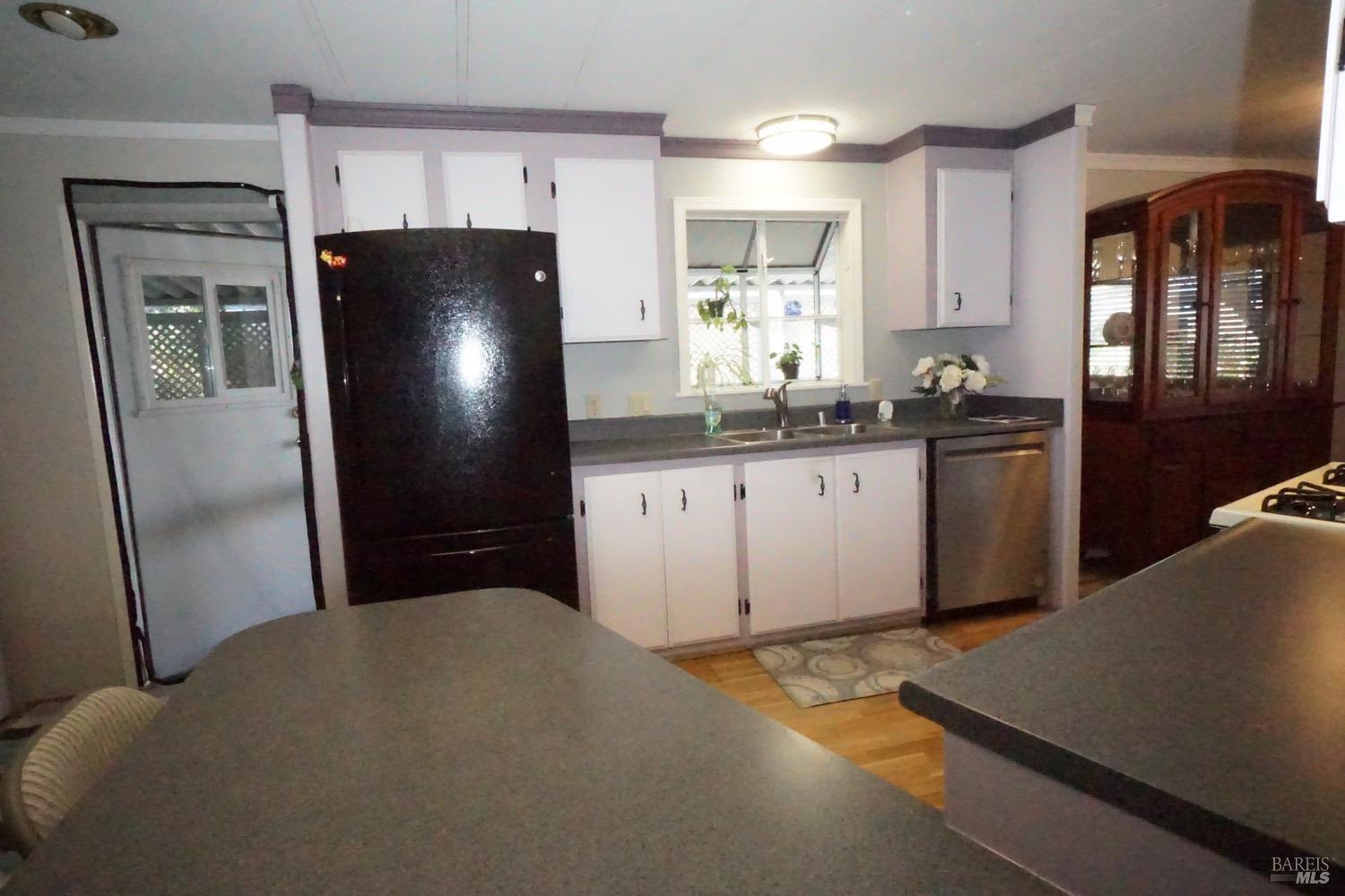 1036 Maple Drive Windsor, CA 95492 - Photo 17 of 28 This view is of the back door, refrigerator, dishwasher, sink.