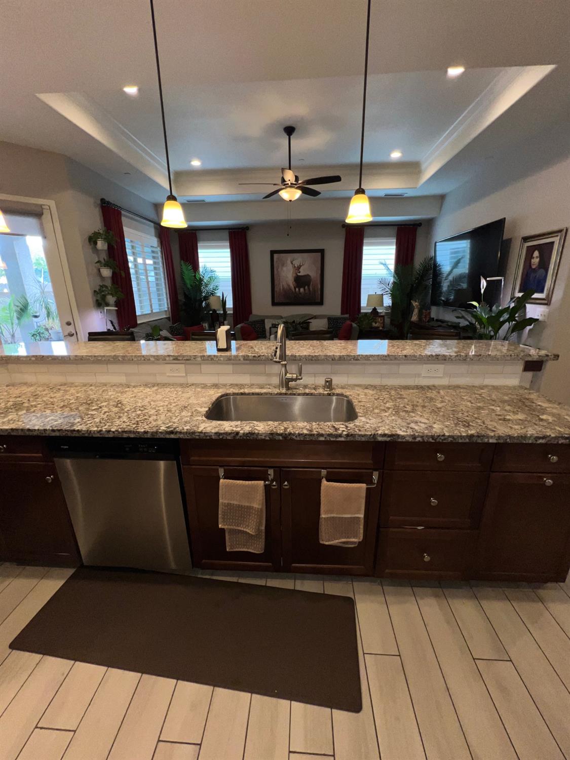 889 Coloma Place Madera, CA 93637 - Photo 15 of 61 a large kitchen with granite countertop a sink a counter space and stainless steel appliances