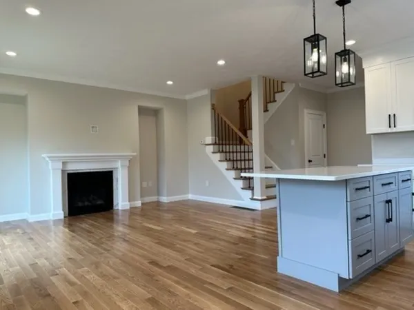 a kitchen with stainless steel appliances granite countertop a sink a stove and a wooden floors