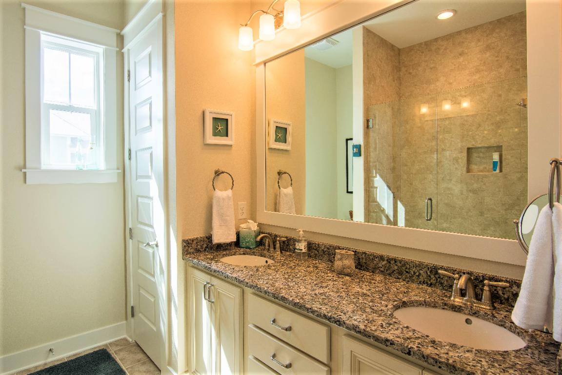95 York Ln Inlet Beach, Unit A Inlet Beach, FL 32461 - Photo 18 of 33 a bathroom with a granite countertop sink and a mirror
