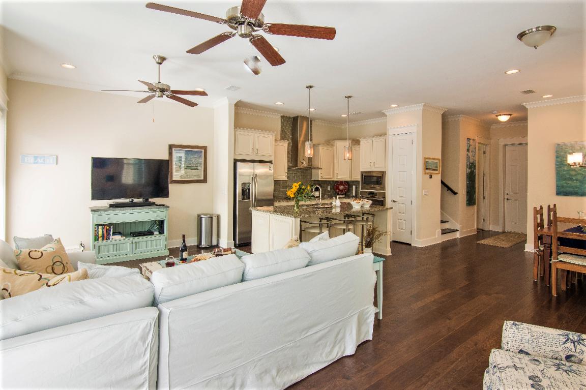 95 York Ln Inlet Beach, Unit A Inlet Beach, FL 32461 - Photo 4 of 33 a living room with furniture and a flat screen tv with kitchen view