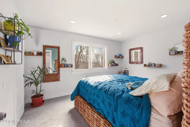 a bedroom with furniture and a potted plant