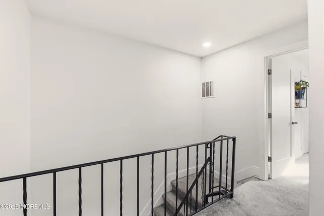 a view of staircase with white walls