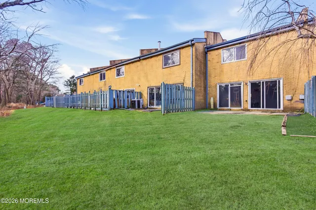 a view of a house with a yard and porch