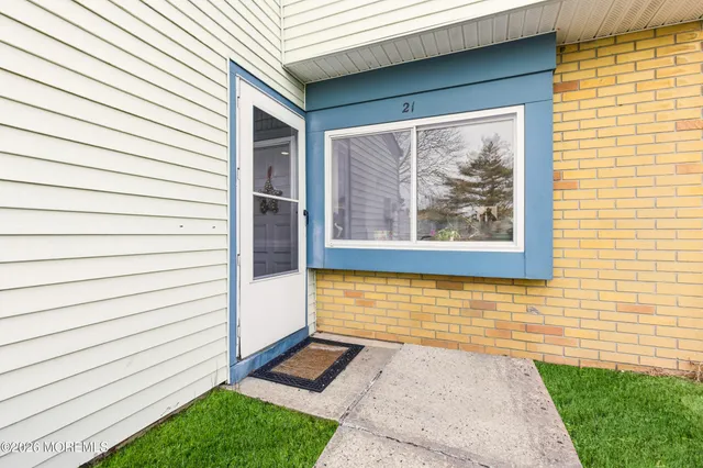a view of a porch with wooden floor and a yard