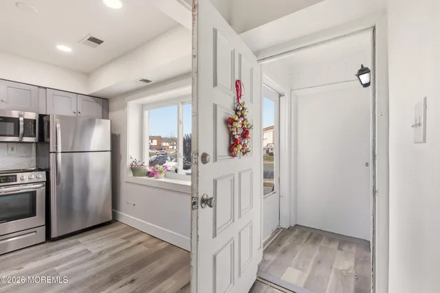a view of hallway with wooden floor