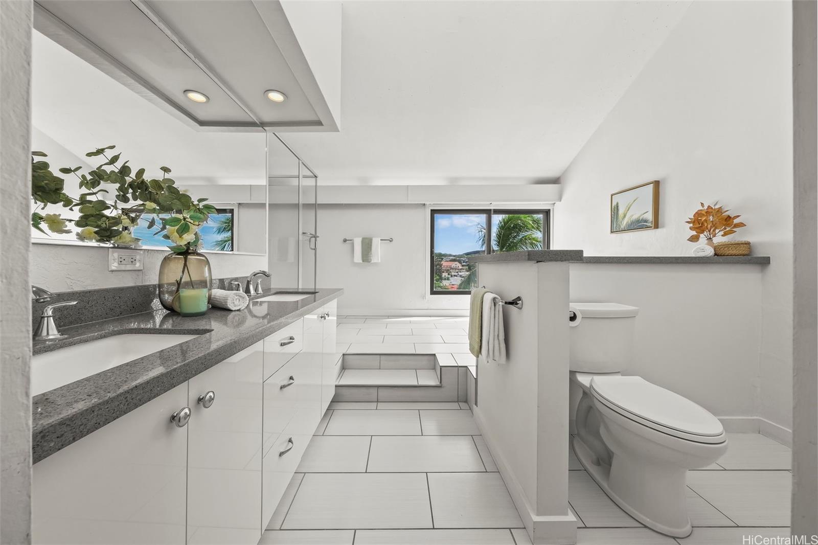 500 Lunalilo Home Road, Unit 17A Honolulu, HI 96825 - Photo 12 of 25 a large white kitchen with a sink and wooden floor