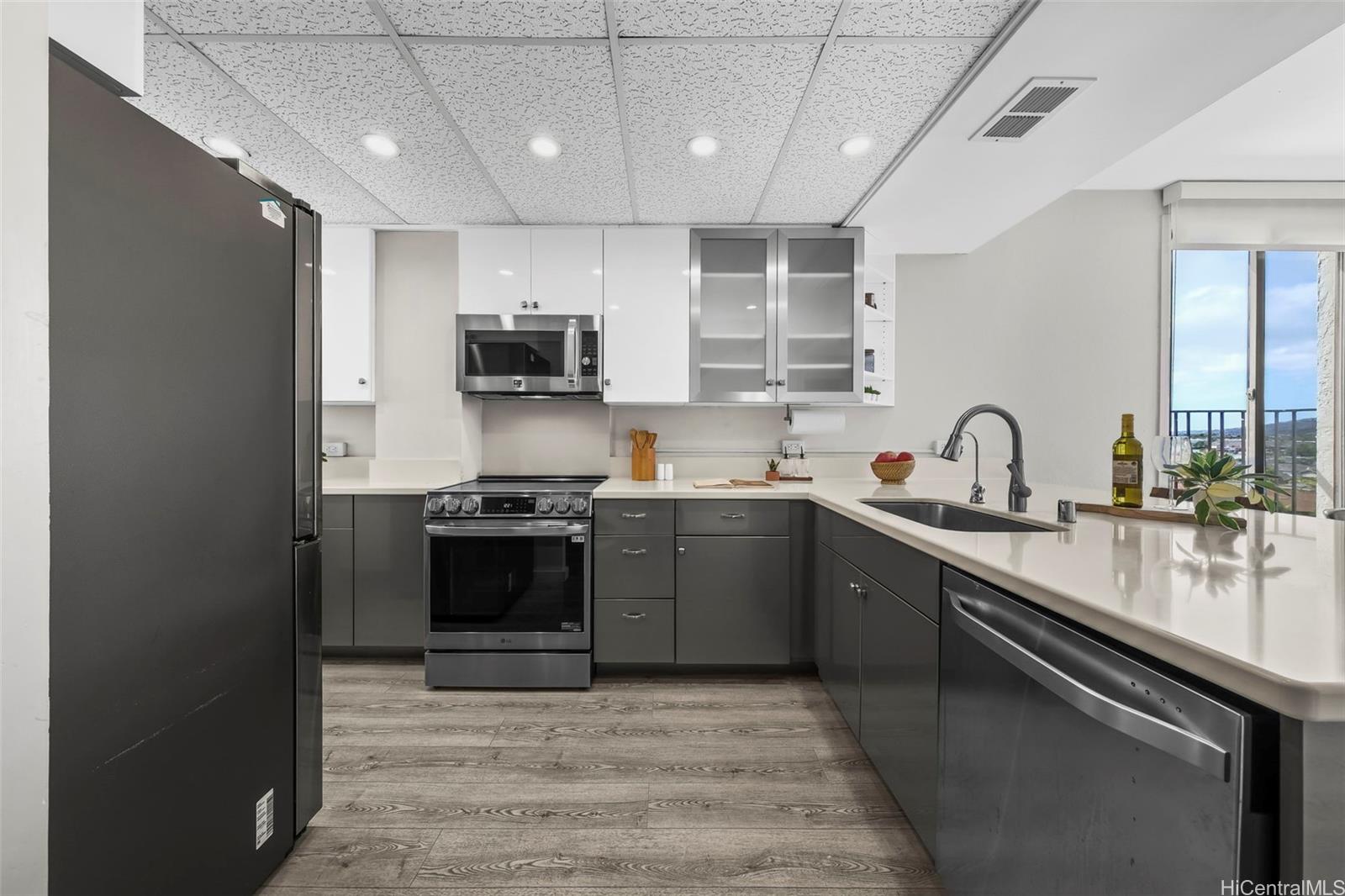 500 Lunalilo Home Road, Unit 17A Honolulu, HI 96825 - Photo 3 of 25 a kitchen with a sink stove and cabinets