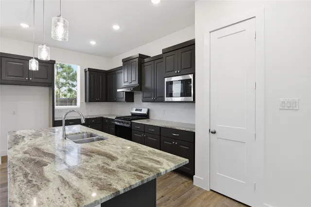 a view of an entryway with wooden floor