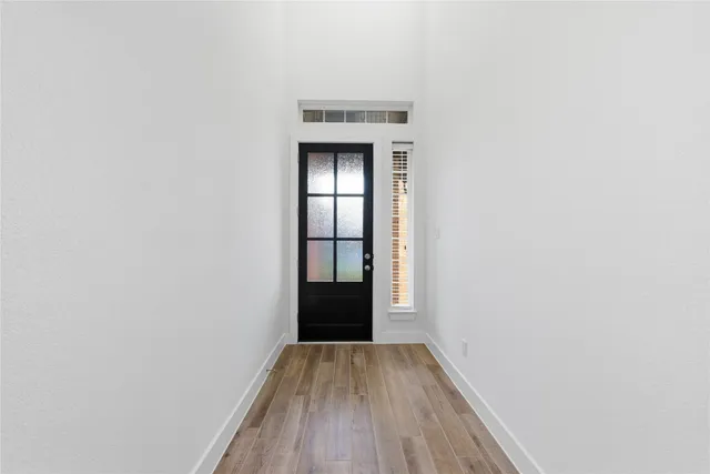 a view of a hallway with wooden floor