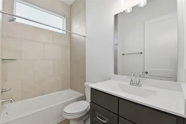 a bathroom with a tub shower and sink