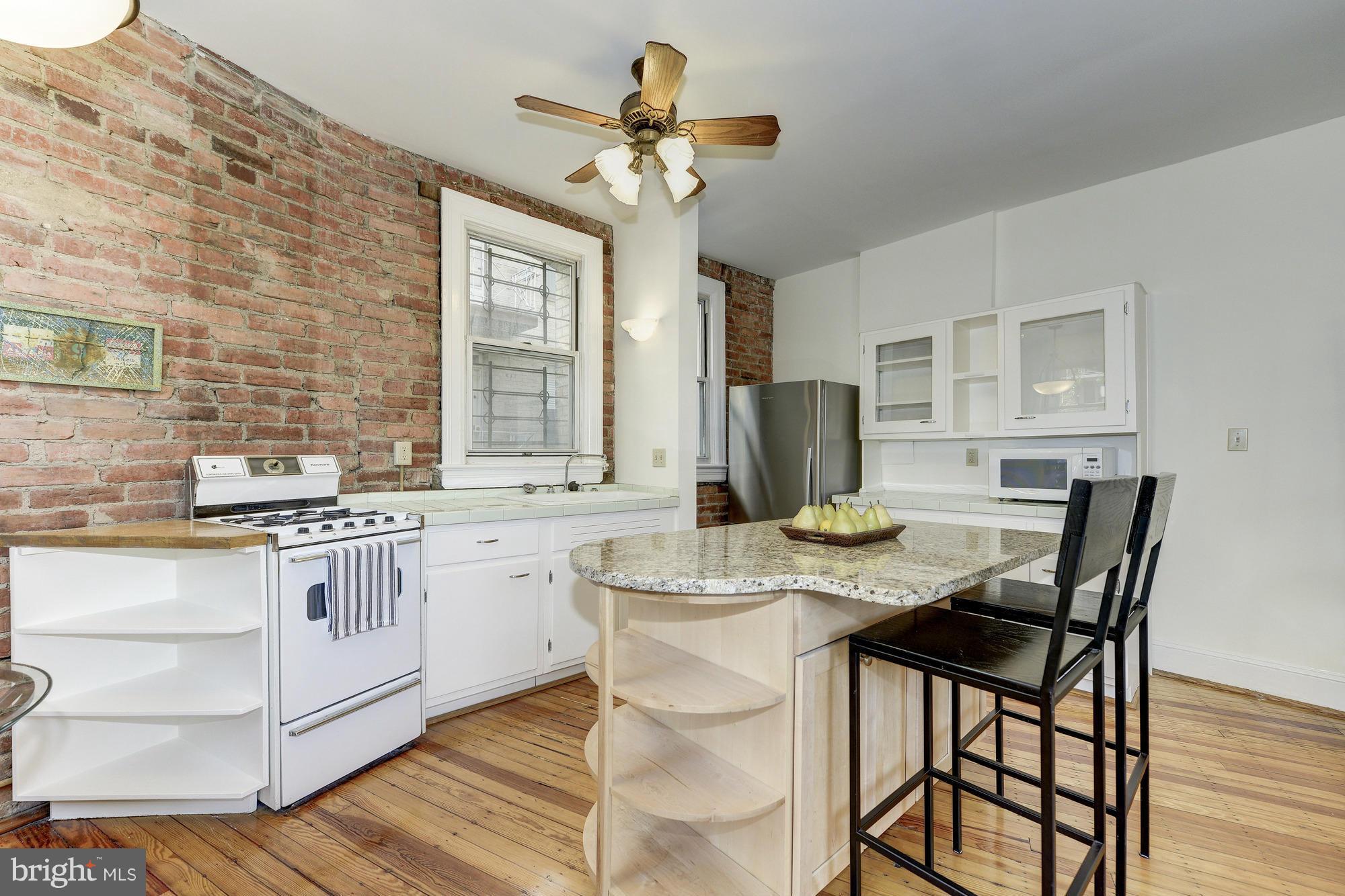 2605 Adams Mill Road Northwest, Unit 2 Washington, DC 20009 - Photo 10 of 30 a view of a dining room with furniture and a chandelier