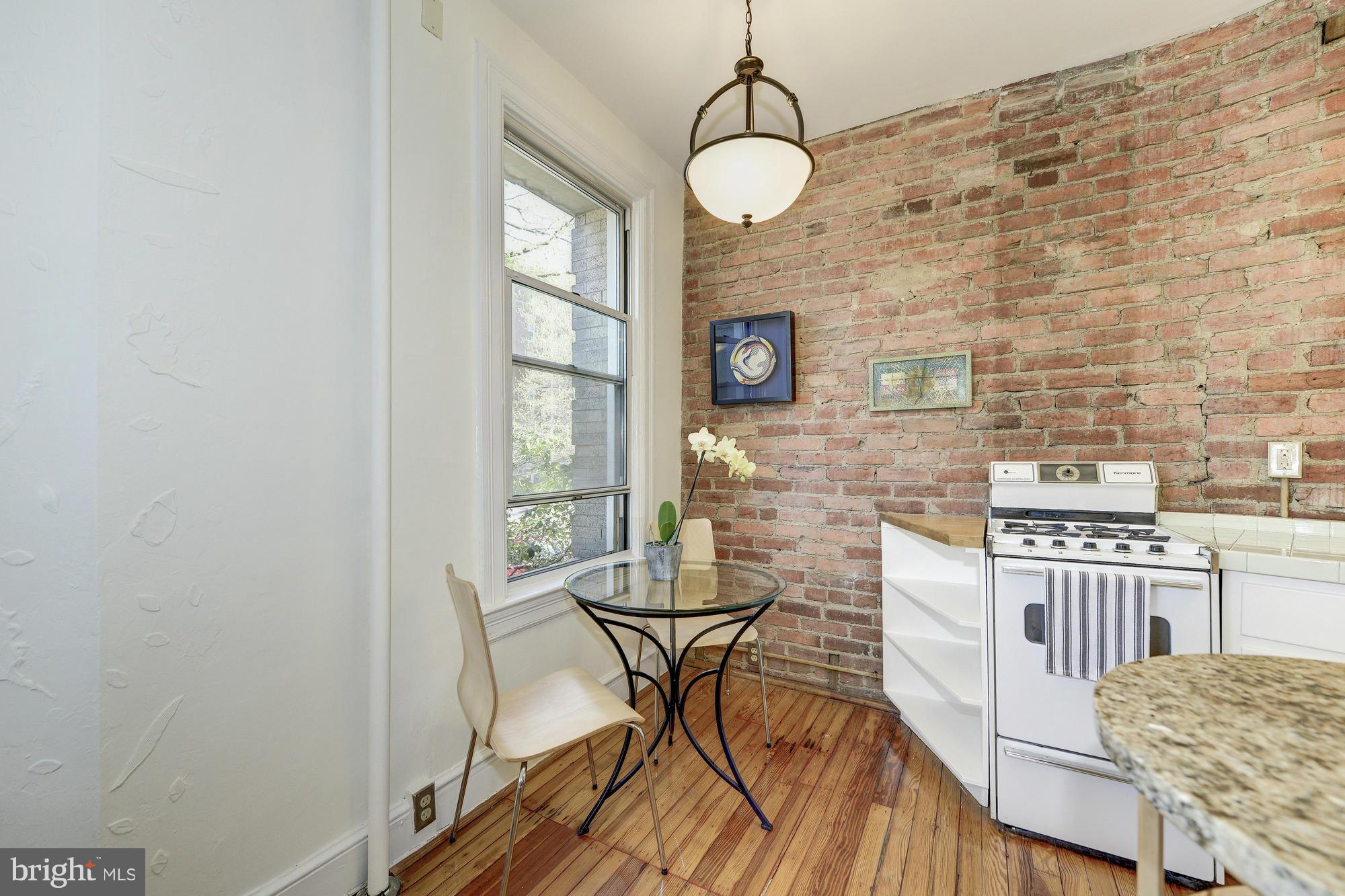 2605 Adams Mill Road Northwest, Unit 2 Washington, DC 20009 - Photo 11 of 30 a view of a dining room with furniture and wooden floor