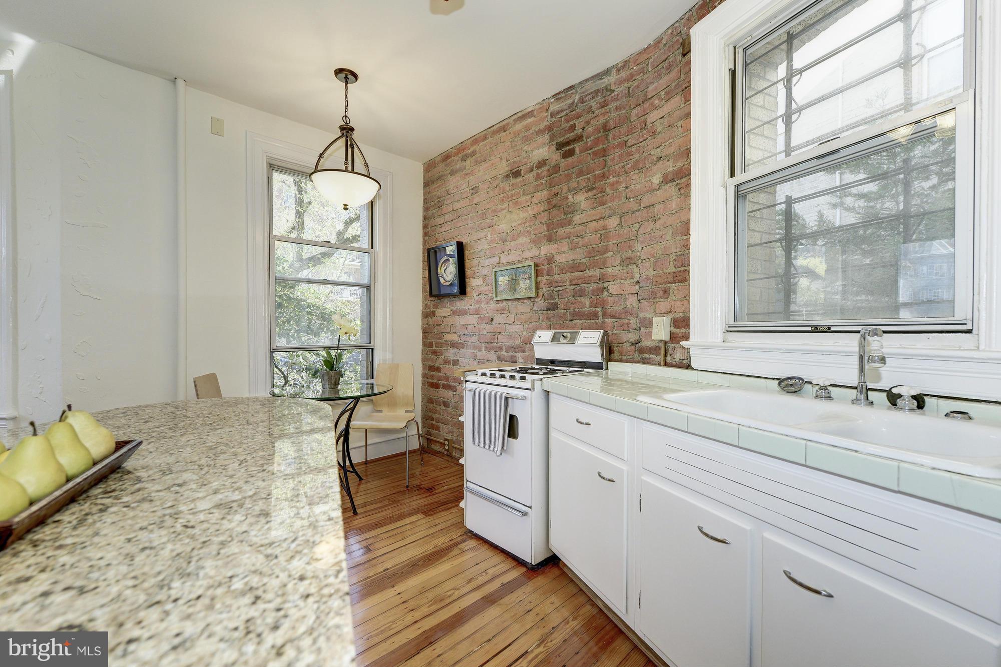 2605 Adams Mill Road Northwest, Unit 2 Washington, DC 20009 - Photo 14 of 30 a spacious bathroom with a granite countertop sink mirror and a bath tub