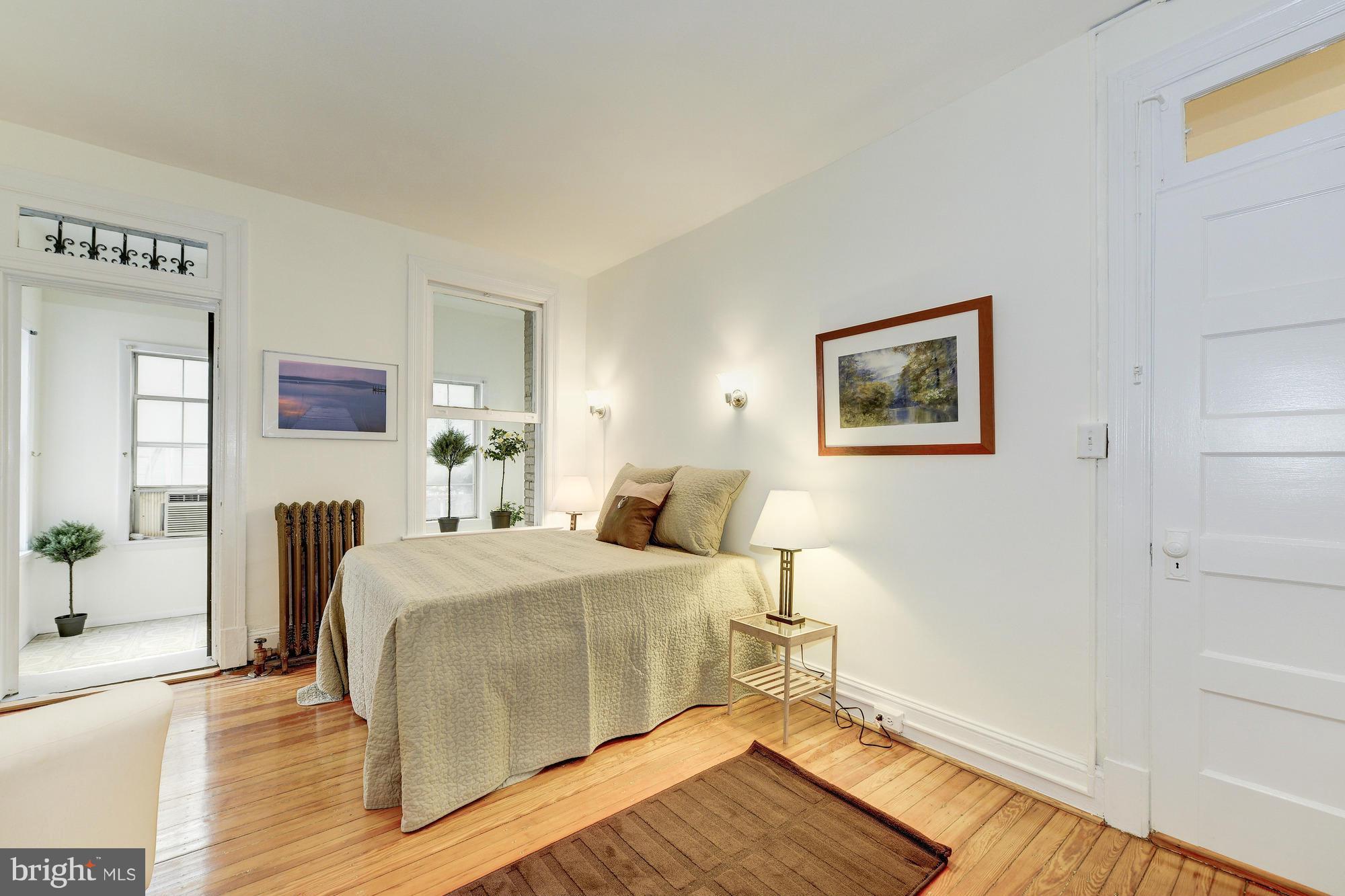 2605 Adams Mill Road Northwest, Unit 2 Washington, DC 20009 - Photo 17 of 30 a bedroom with a bed and wooden floor