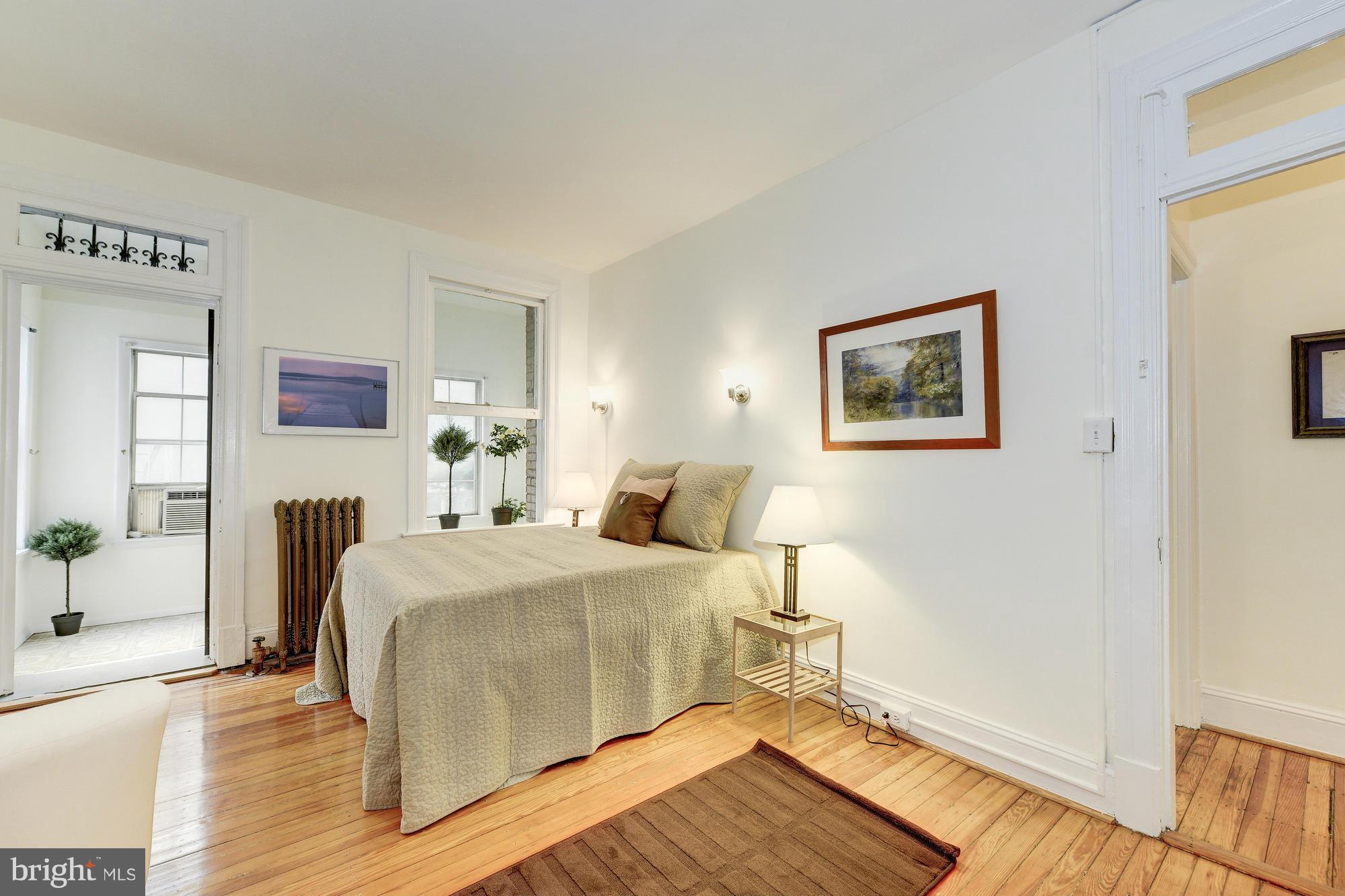 2605 Adams Mill Road Northwest, Unit 2 Washington, DC 20009 - Photo 18 of 30 a bedroom with a bed and wooden floor