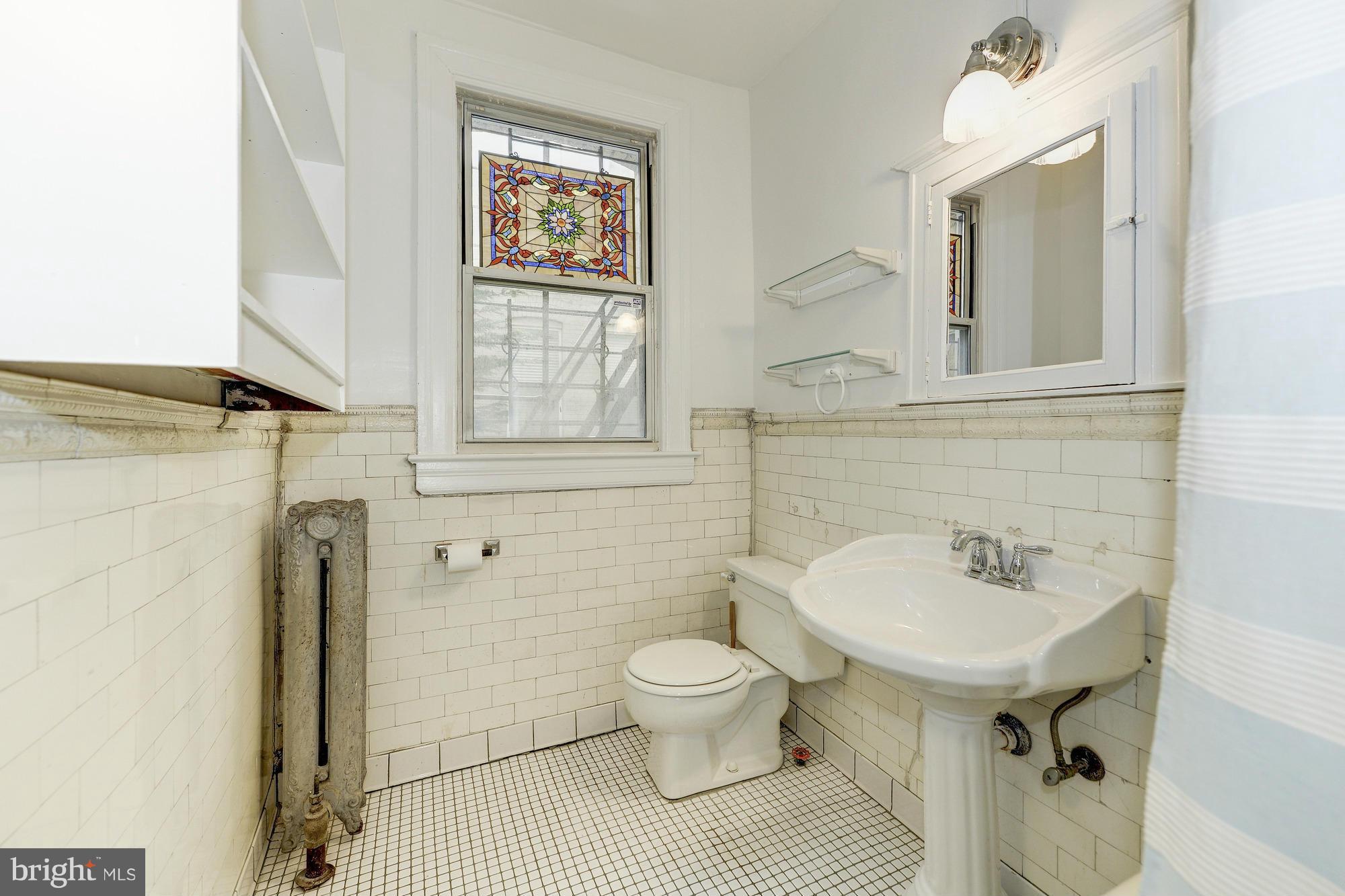 2605 Adams Mill Road Northwest, Unit 2 Washington, DC 20009 - Photo 23 of 30 a bathroom with a sink toilet and shower