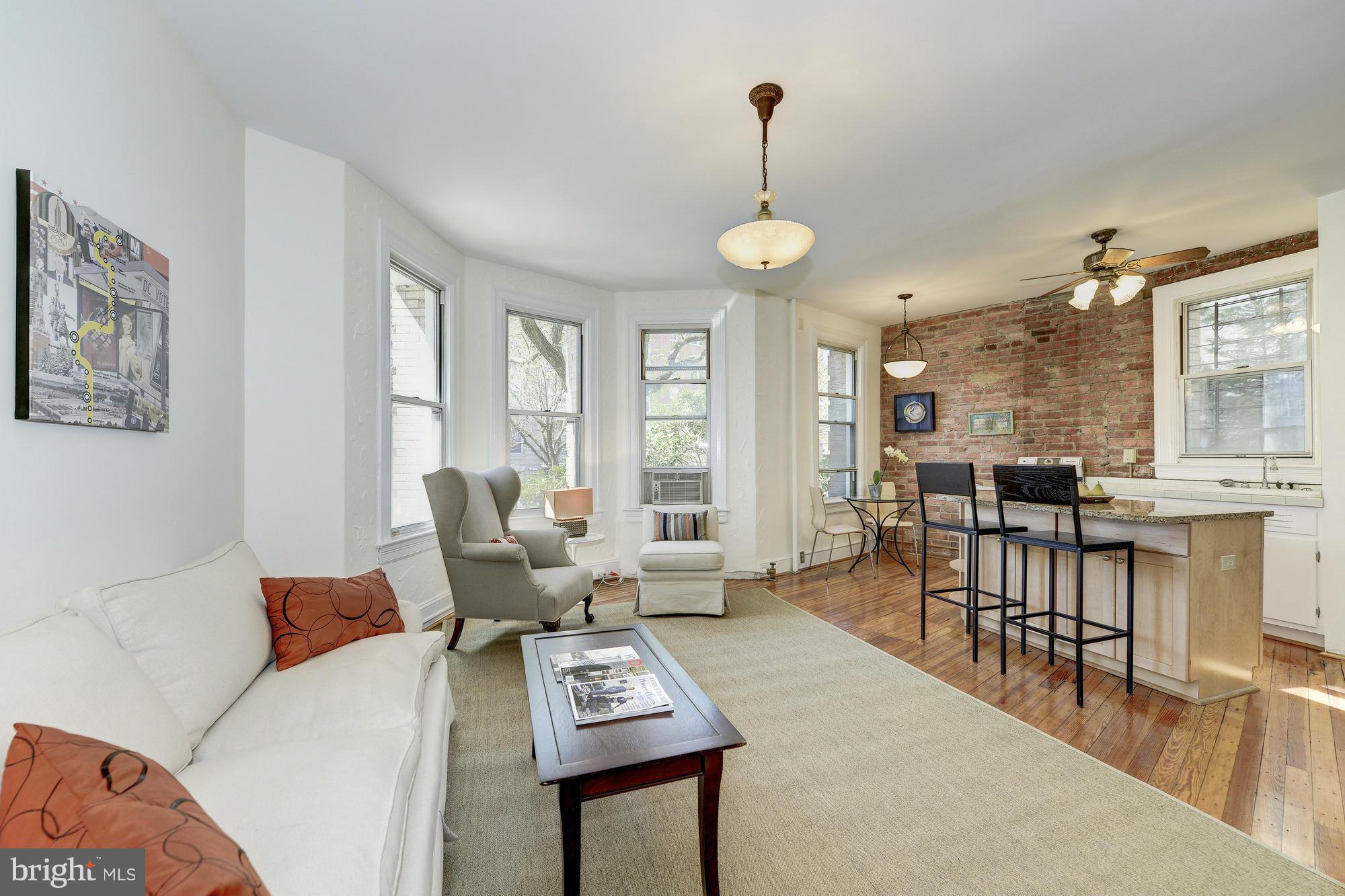 2605 Adams Mill Road Northwest, Unit 2 Washington, DC 20009 - Photo 6 of 30 a living room with furniture and a table
