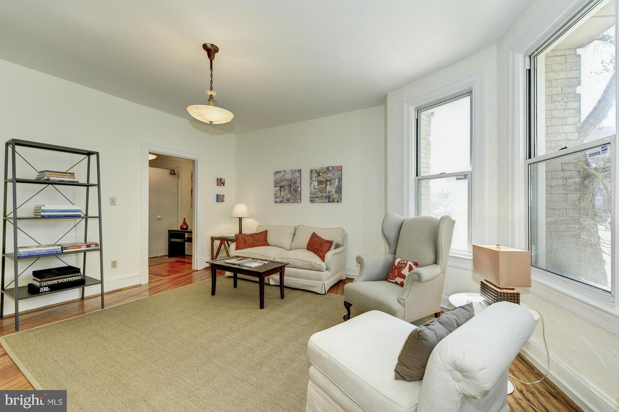 2605 Adams Mill Road Northwest, Unit 2 Washington, DC 20009 - Photo 8 of 30 a living room with furniture a window and a table