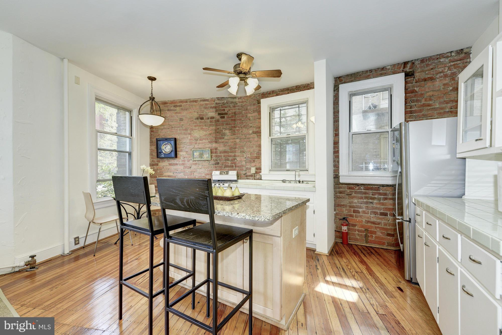 2605 Adams Mill Road Northwest, Unit 2 Washington, DC 20009 - Photo 9 of 30 a view of a dining room with furniture and a chandelier