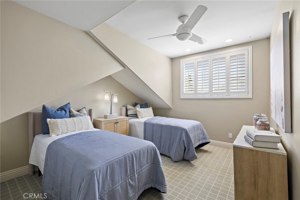 4 Celestine Circle Ladera Ranch, CA 92694 - Photo 23 of 39 a bedroom with two beds and a chandelier