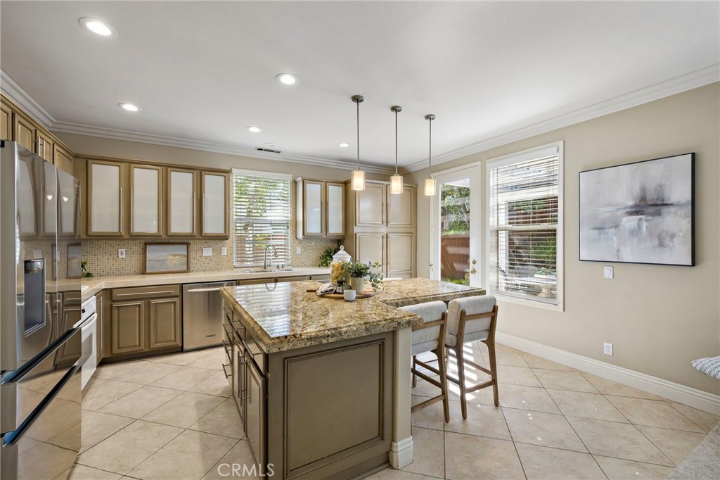 4 Celestine Circle Ladera Ranch, CA 92694 - Photo 7 of 39 a kitchen with kitchen island granite countertop lots of counter top space and stainless steel appliances