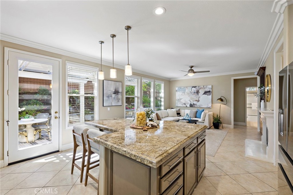 4 Celestine Circle Ladera Ranch, CA 92694 - Photo 10 of 39 a kitchen with granite countertop a dining table chairs and large windows